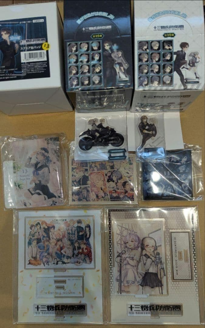 十三機兵防衛圏 アクリルスタンド 缶バッジ box特典付き 十三機兵防衛圏」，発売1周年を記念した各種グッズの予約受付を